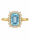 Anillo en oro de 18K con aguamarina azul rectangular rodeada por un halo de diamantes de 0,10 ct