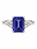 Anillo de oro blanco con tanzanita rectangular azul violeta y diamantes laterales